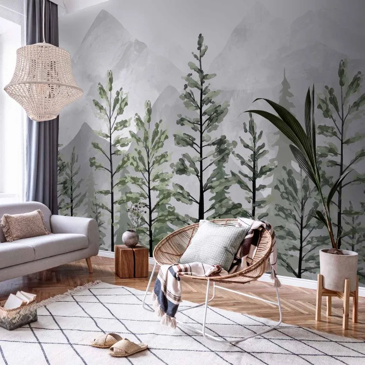 Mountain landscape - tall green trees on a background of pointed grey mountains